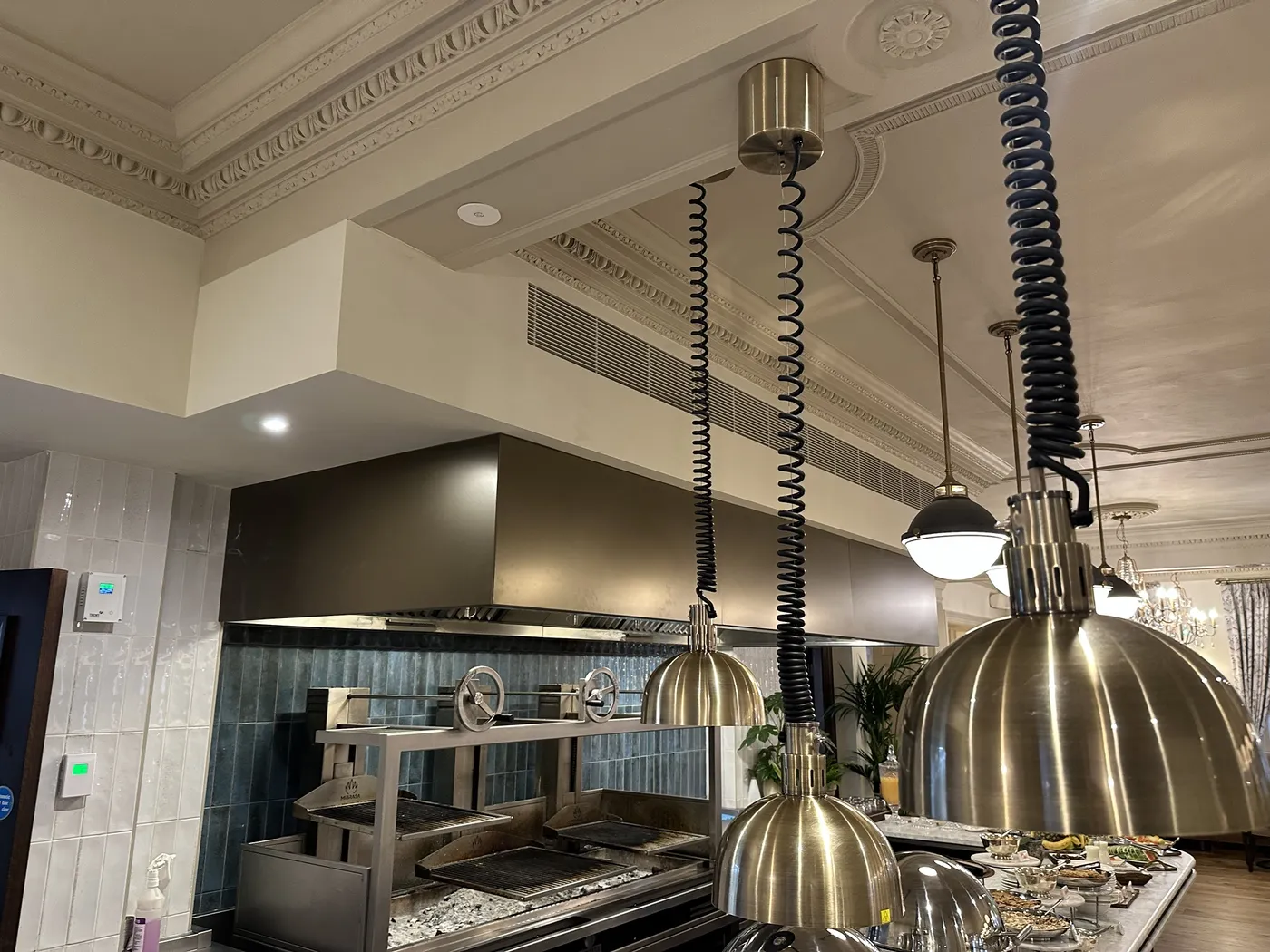 Front-of-house canopy over charcoal grills in the restaurant at the Francis Hotel, with linear supply air grille in the bulkhead above
