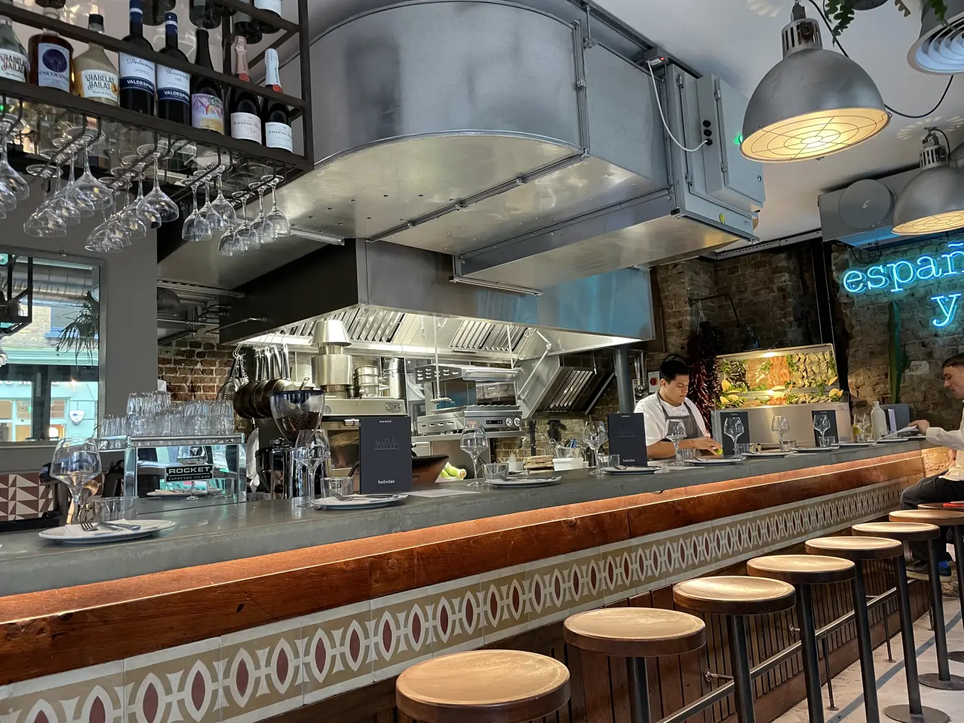 Front-of-house canopy with baffle filters above the open kitchen and bar counter at Maresco, Soho